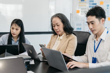 Group of Young Asian business team creative businesspeople coworker in office. Meeting Presentation for analysis graph company financial. People Work in Business Office.