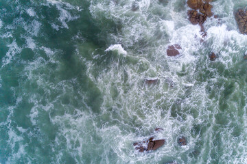 drone view of the seashore with rough seas on a rocky shore