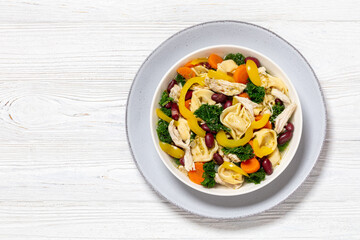 chicken minestrone soup with tortelloni in bowl