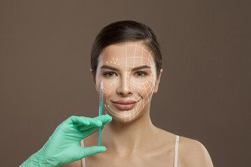 Happy woman with arrow lines on her face for lifting skin and syringe in medical hand. Medicine, injection and anti-aging concept