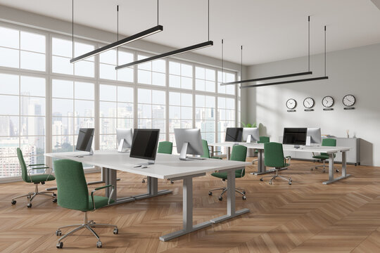 Stylish office interior with pc monitors, world clock and panoramic window