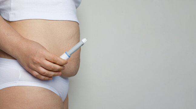 Female model showing opened Semaglutide Injection pen or insulin cartridge pen. Weight loss and diabetes concept.