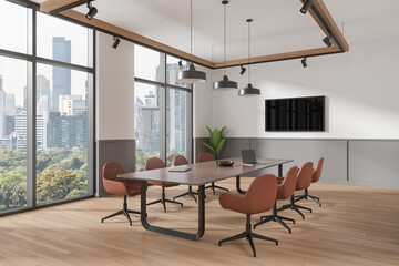 Cozy conference interior with table and chairs, tv screen and panoramic window