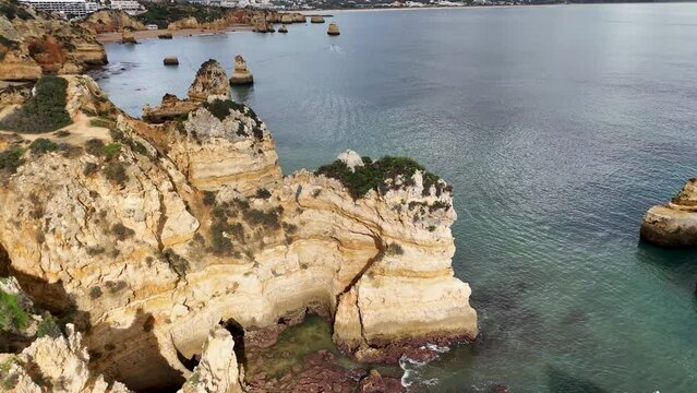 The beautiful Praia do Camilo with its golden sandstone cliffs located in Lagos on the Algarve region of southern Portugal.