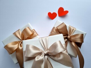 Three gift boxes with paper hearts