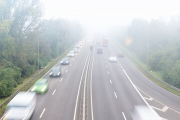 Scenic city highway road traffic jam many cars at foggy misty rainy haze morning low poor...