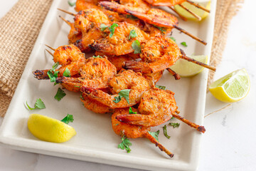 Grilled Shrimp on Skewers with Lemon Close Up Photo