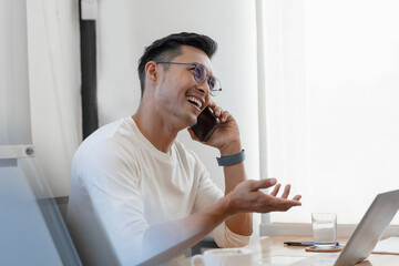 Fototapeta premium Happy middle aged business man ceo wearing suit sitting in office using digital tablet. Smiling mature businessman professional executive manager looking away thinking working on tech device.