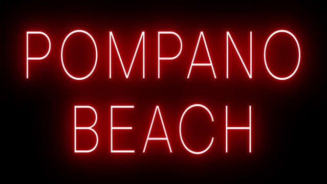 Flickering red retro style neon sign glowing against a black background for POMPANO BEACH