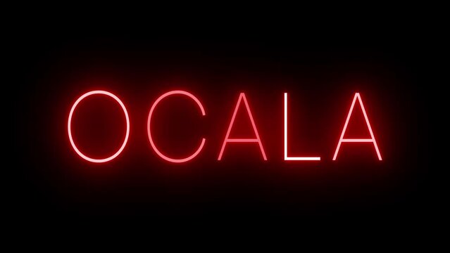 Flickering red retro style neon sign glowing against a black background for OCALA