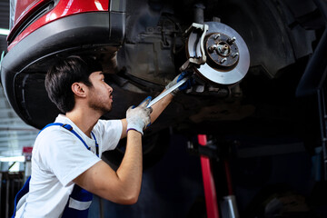 Engine mechanic working under car Auto mechanic working in garage Repair and maintenance services.