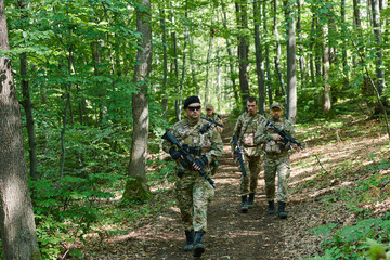 A specialized military antiterrorist unit conducts a covert operation in dense, hazardous woodland,...