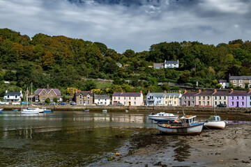Fototapeta na wymiar Old Harbor With Boats In The Village Fishguard At The Atlantic Coast Of Pembrokeshire In Wales, United Kingdom