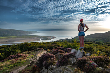 Young Woman Looks Over Mawddach River Estuary In Snowdonia National Park Near The City Of Barmouth...
