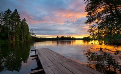 Sunset on a forest lake in summer.A great place to relax by the water. Fresh air in nature.Summer...