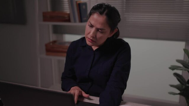 Woman reads emails on laptop at night, feels depressed after receiving bad news online Failed to pass professional exam Receive notification of termination Unemployment concept