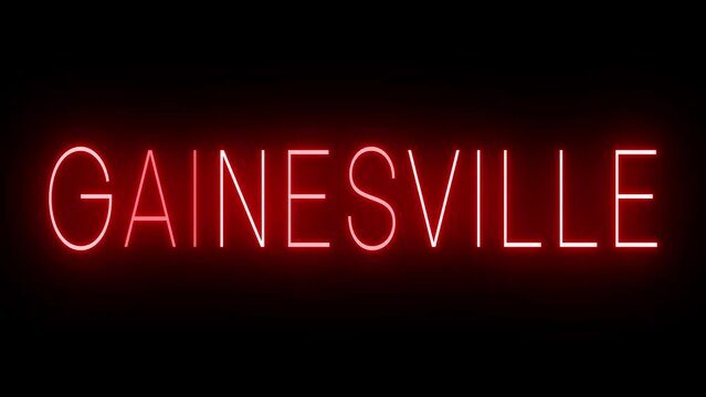 Flickering red retro style neon sign glowing against a black background for GAINESVILLE
