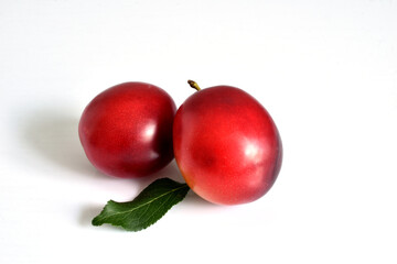 Two ripe plum fruits.
