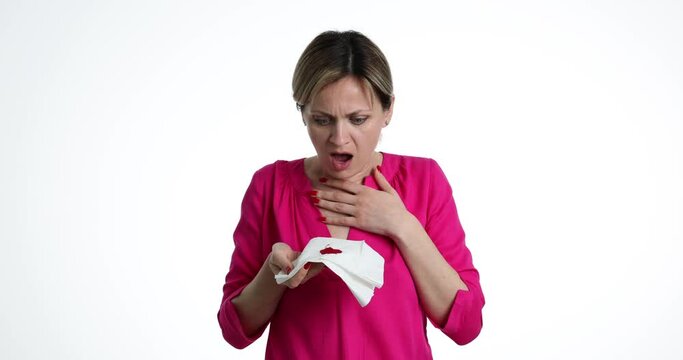 Woman coughing up blood with hands and holding tissue paper with blood. Hemoptysis or coughing up blood