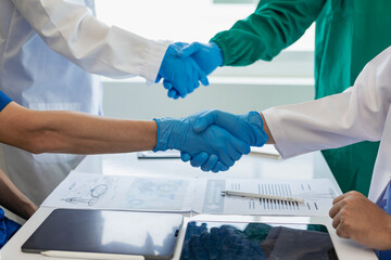 The medical team joins hands and works togetherGroup of scientists joining hands to create...