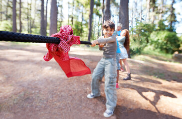 Pull. Children, game and tug of war in forest, summer camp and holiday with travel and energy outdoor. Kids, adventure and team building with competition, playful and young people in group for fun. - obrazy, fototapety, plakaty