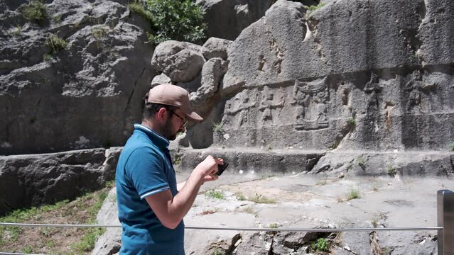 An archaeologist conducts research using modern methods in Yazilikaya in Hattusa, ancient capital of the Hittite Civilization - Corum, Turkey