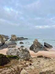 Rocky ocean coast, mist and fog at the ocean bay, rocks at the ocean coast, impressive
