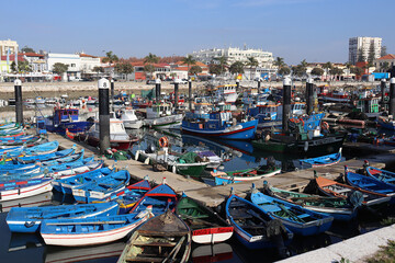 Boats anchored in a marina, with small wooden fishing boats in the foreground. Fishermen's Dock in...