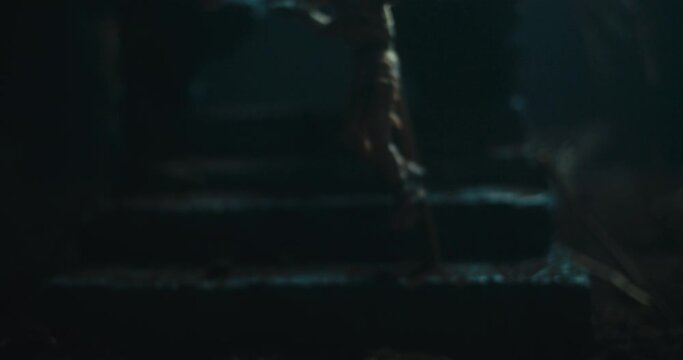 A dead mummified man hanging on the gallows on the fog-covered evil altar