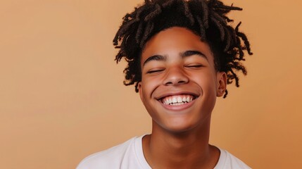 Happy young African American gen z guy winking isolated on beige background. Playful ethnic teen student, cool curly generation z teenager smiling - obrazy, fototapety, plakaty