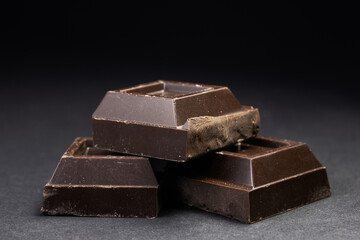 Dark chocolate stack, chips and powder close up