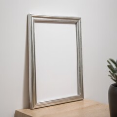 Silver picture frame on white wall, mockup