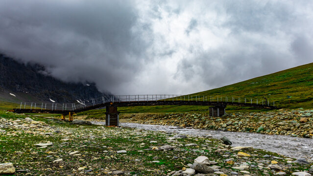 Mountain trail in Norway. Rainy weather in the mountains. Bridge on the trail in the Trollheimen mountains.