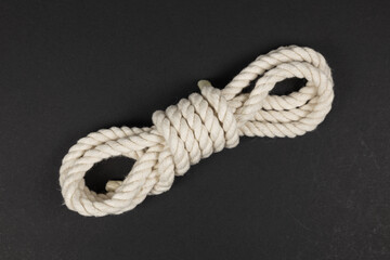 beige rope on dark background close up