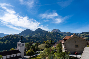 Fototapeta na wymiar View of the city of Gruyere in Switzerland and the surrounding mountains on a sunny day 