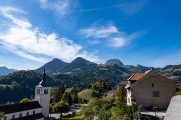 View of the city of Gruyere in Switzerland and the surrounding mountains on a sunny day 