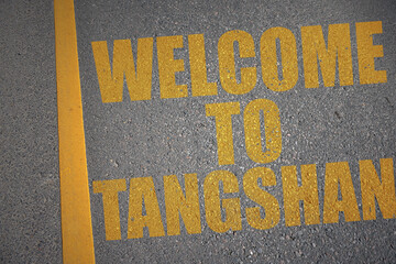 asphalt road with text welcome to tangshan near yellow line.