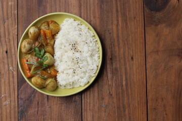 Vegetable curry egg with rice on wooden table. Top View.