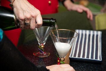 bartender pouring cocktail into glass