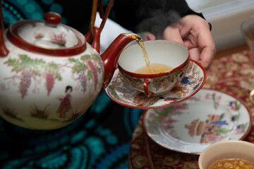 pouring tea into a cup