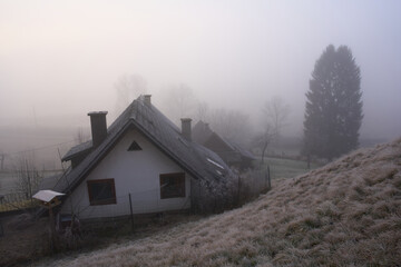 Winter landscape with countryside house and trees