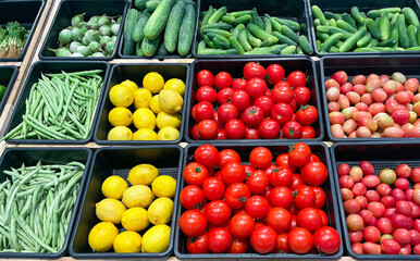 Fresh organic vegetables in basket for selling in the supermarket. Tomato, Lemon, cucumber, green brinjal eggplant, long beans