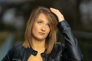 Young woman in her thirties photographed in portraits on a bridge with flash.