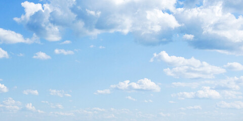 A clear sky with fluffy, white clouds scattered across the blue expanse.