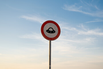 No entry for UFO traffic sign, isolated sunset sky. © Ali Azem