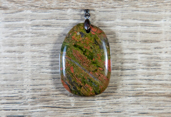 A close-up with an unakite stone pendant