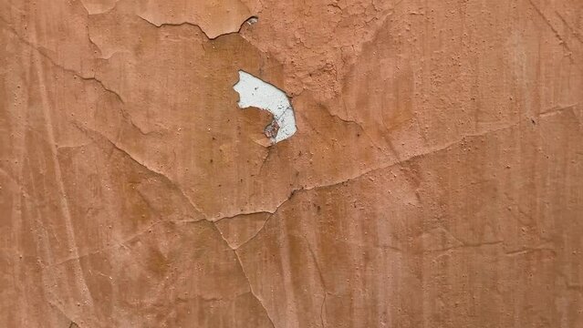 Peeling paint on the wall. Weathered rough painted surface with patterns of cracks and peeling. Wide panoramic grunge texture for background