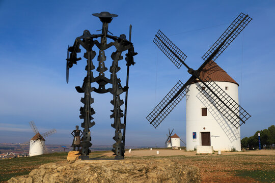 Beautiful windmills and Don Quixote statue in Mota del Cuervo town, in Spain