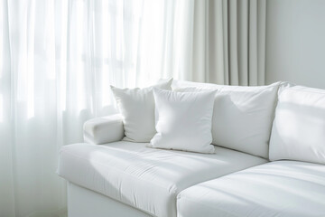 White square pillow on white sofa.