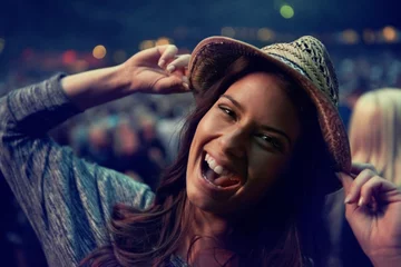 Fotobehang Happy woman, portrait and face at music festival party, event or DJ concert for outdoor night. Excited female person smile in evening crowd or audience at carnival, performance or summer fest outside © Jeff Bergen/peopleimages.com
